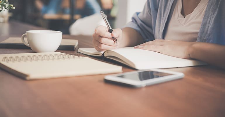  man writing in a notebook